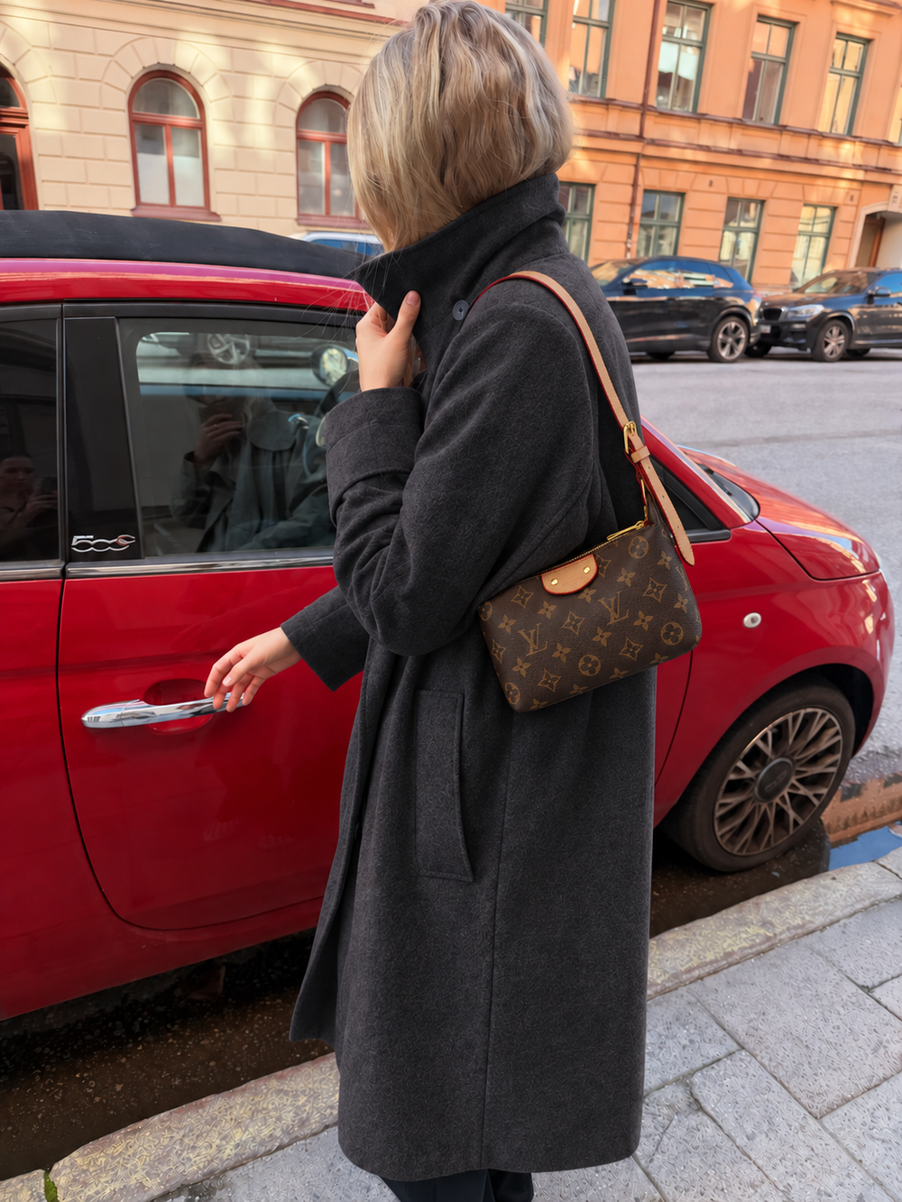 Brown monogram shoulder bag styled with a charcoal coat