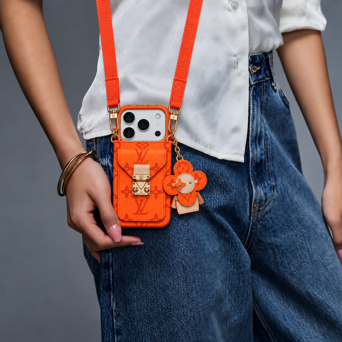 Orange monogram iPhone case with pocket and flower charm — white blouse and denim, view 01