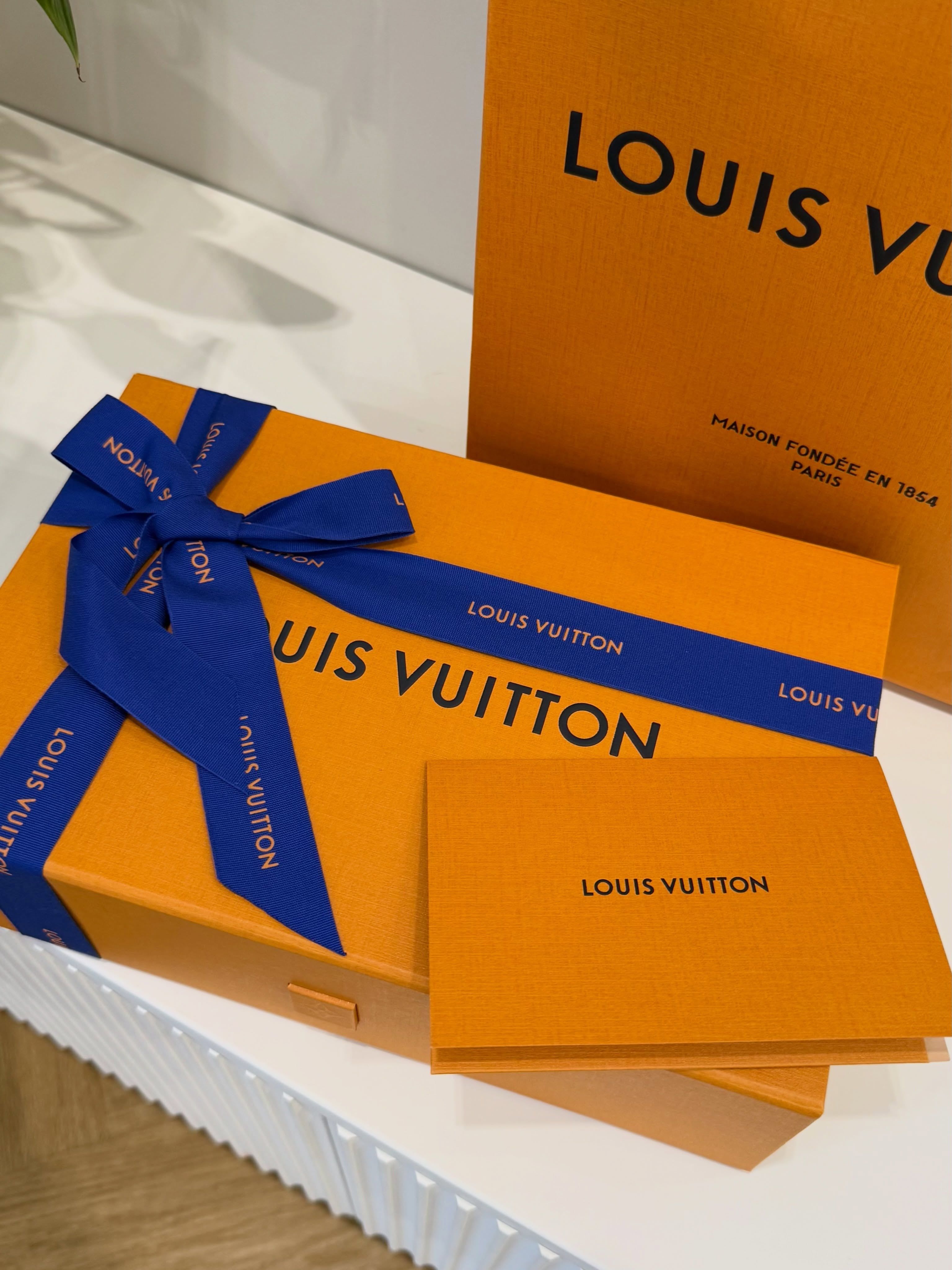 Orange gift packaging with blue ribbons